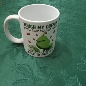 Novelty Grinch mug with suggested act of violence if coffee touched